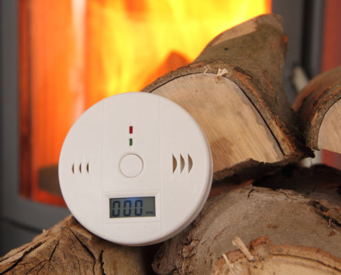 CO Detector in Front of a Burning Fireplace