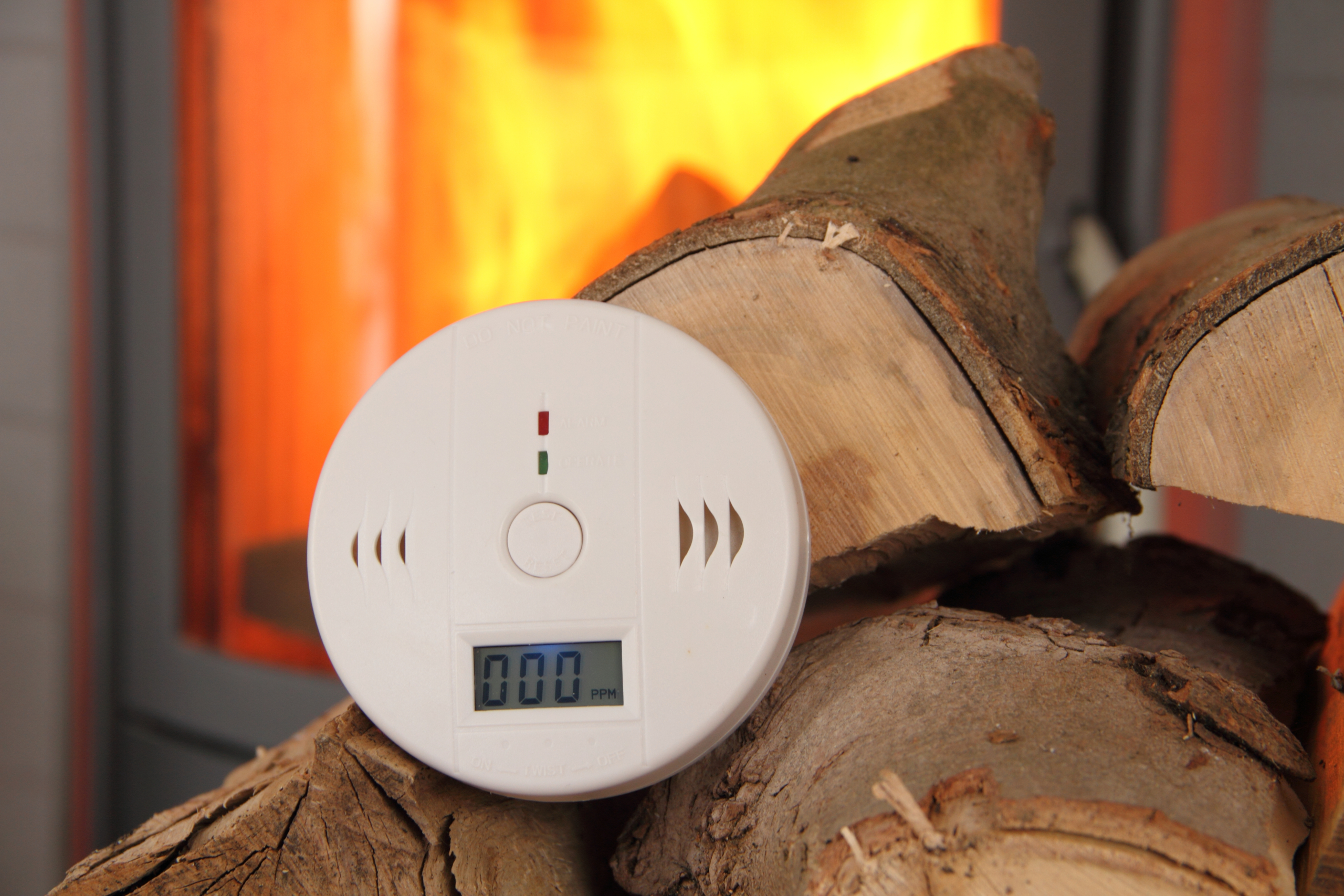 CO Detector in Front of a Burning Fireplace